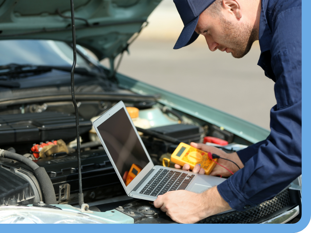 mechanic running diagnostics on car engine