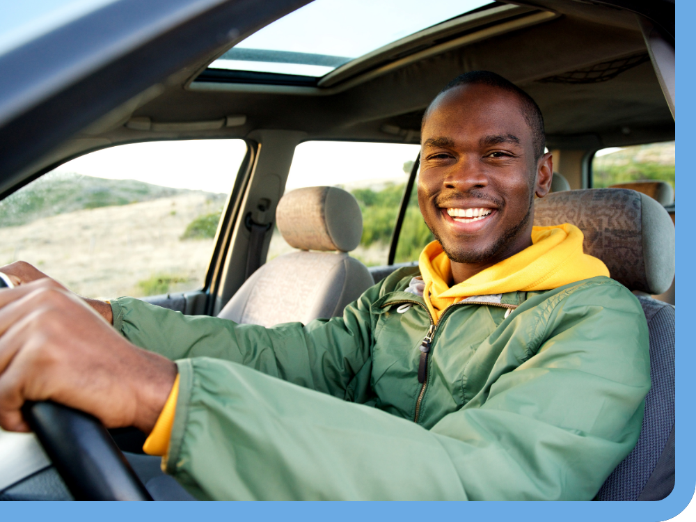 man driving car smiling